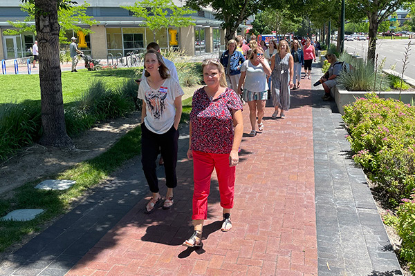 Participants of the Coaching Institute walk in a line down the sidewalk during a fire drill. Click to enlarge.