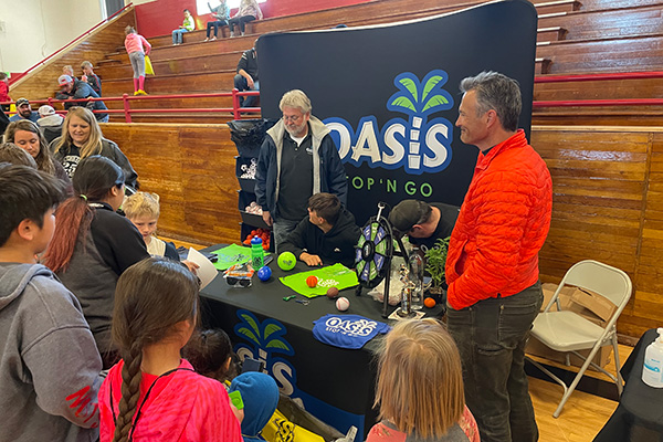 A group of people around an Oasis information table. Click to enlarge.